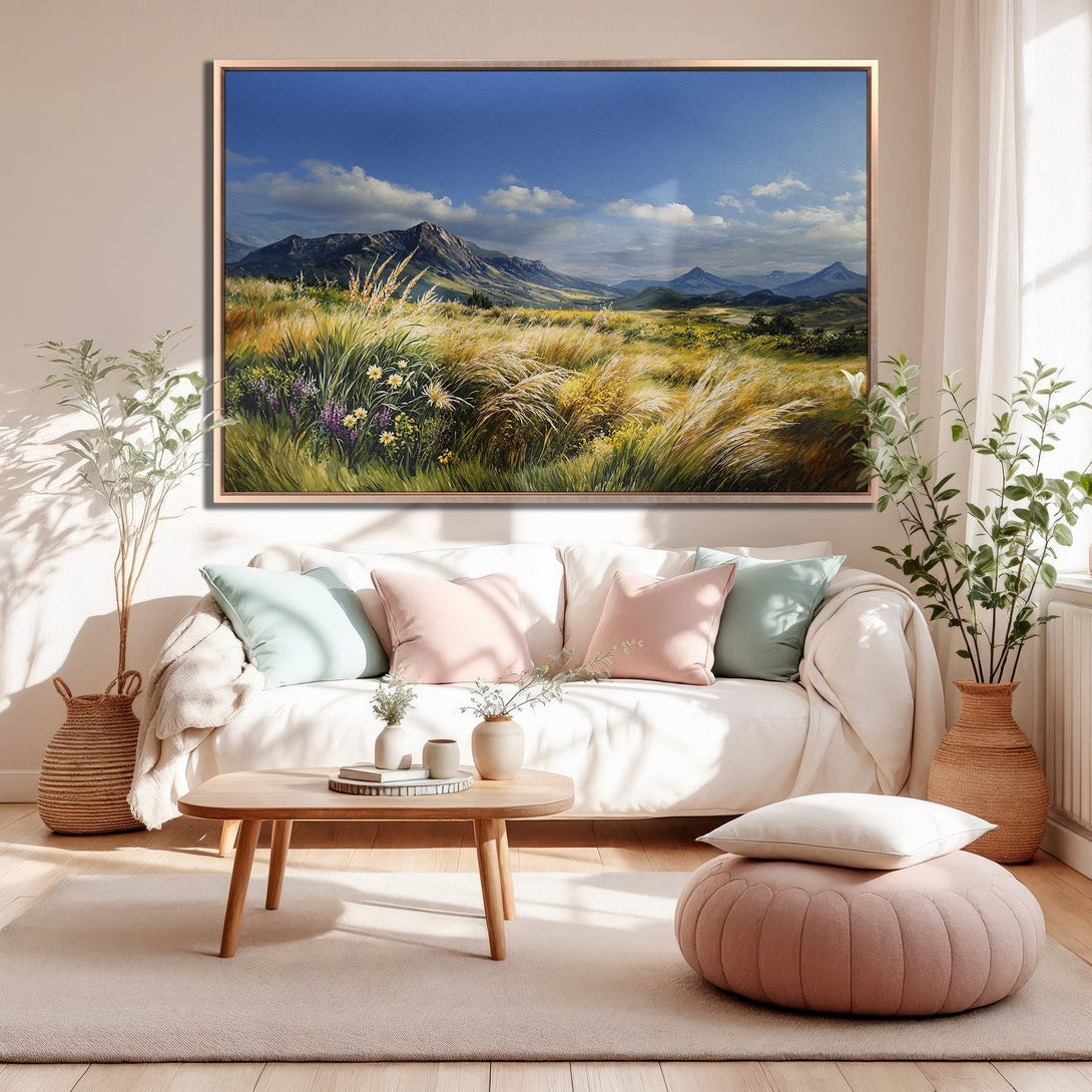Framed Wall Art: Landscape Canvas Print in warm tones. Serene mountain scene with blue sky, green and yellow fields, and a soft, neutral color palette.