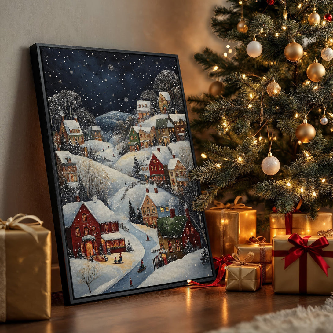 Framed Wall Art of a snowy village scene, perfect for Christmas decor. Features a cozy, warm color palette with red and blue hues.