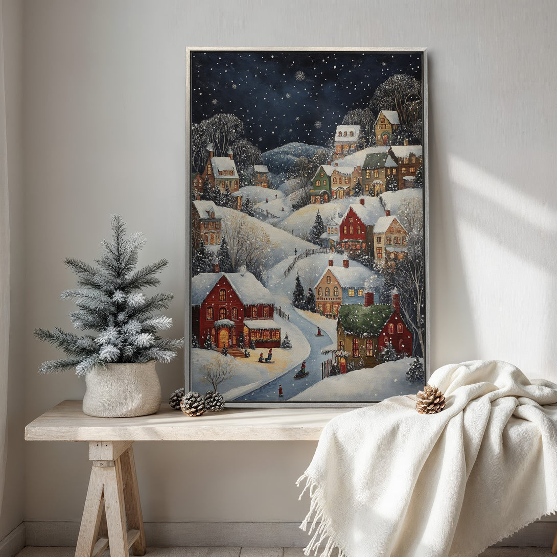 Framed Wall Art: Winter village scene canvas print. Cozy, whimsical style with red, green, and blue hues. Perfect holiday decor for your home.
