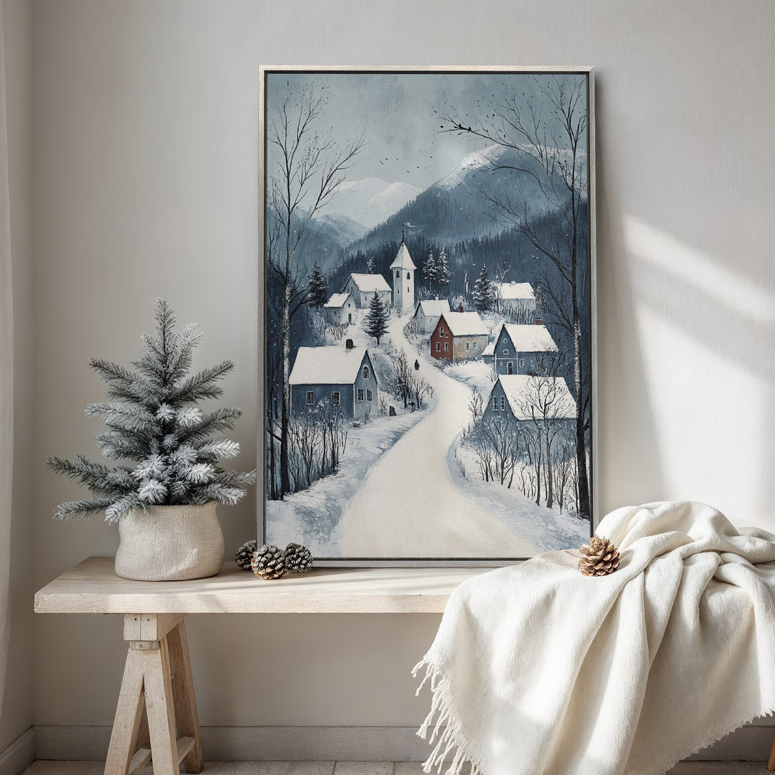 Framed Wall Art: Winter village scene in cool blue and grey tones. Perfect for cozy home decor. Canvas print of a snowy landscape.