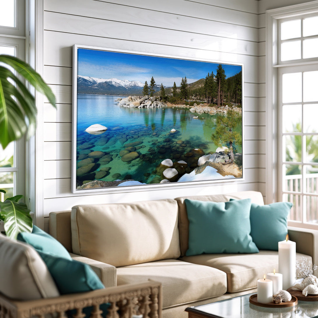 Framed Wall Art featuring a serene lake scene with mountains, trees, and clear blue water. Coastal-style interior with a calming blue and neutral color palette.