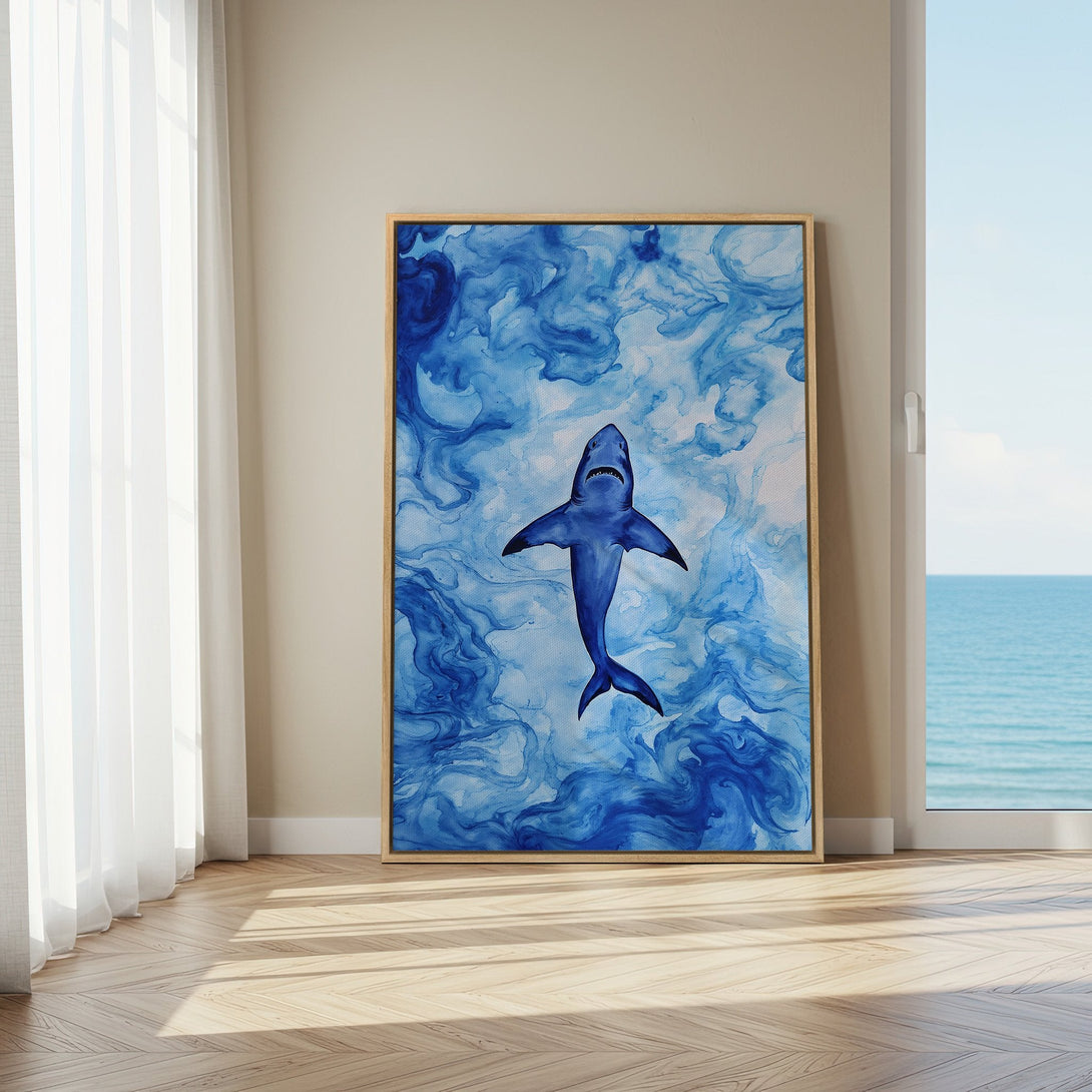 Framed Wall Art featuring a majestic blue shark swimming in abstract blue water, perfect for coastal decor. Modern art with a calming color palette.