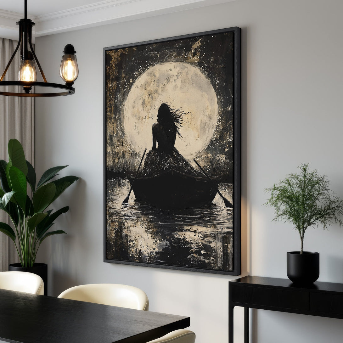 Framed Wall Art: Woman in boat under moon. Abstract black, white, and gold canvas print. Perfect for modern decor. Shop now for unique wall art!