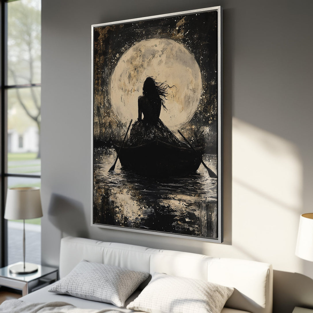 Framed Wall Art: Silhouette of a woman in a boat under the moon. Dramatic black and gold artwork, perfect for bedroom decor.