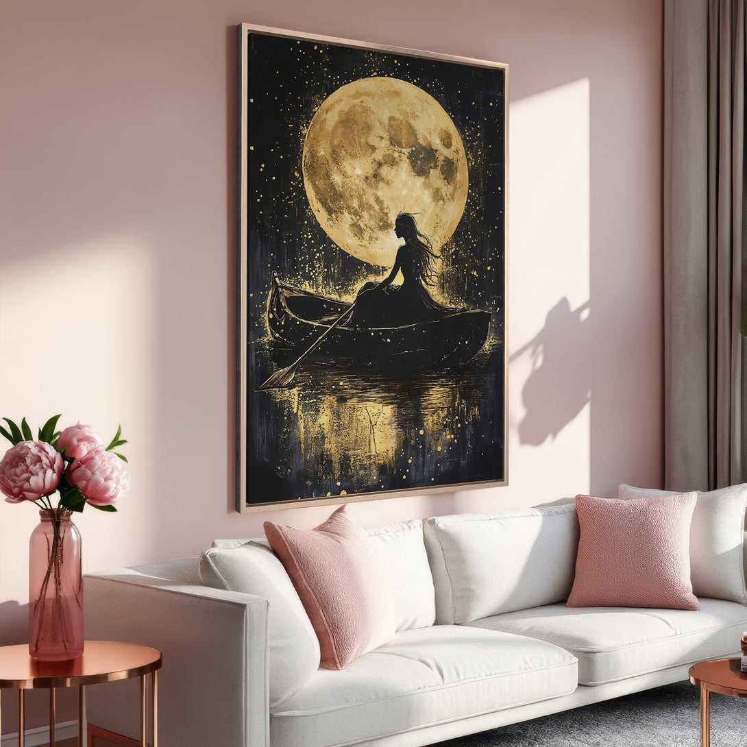 Framed Wall Art: Silhouette of woman in boat under a golden moon. Romantic, artistic canvas print with black, gold, and blush pink color palette. Perfect for home decor.
