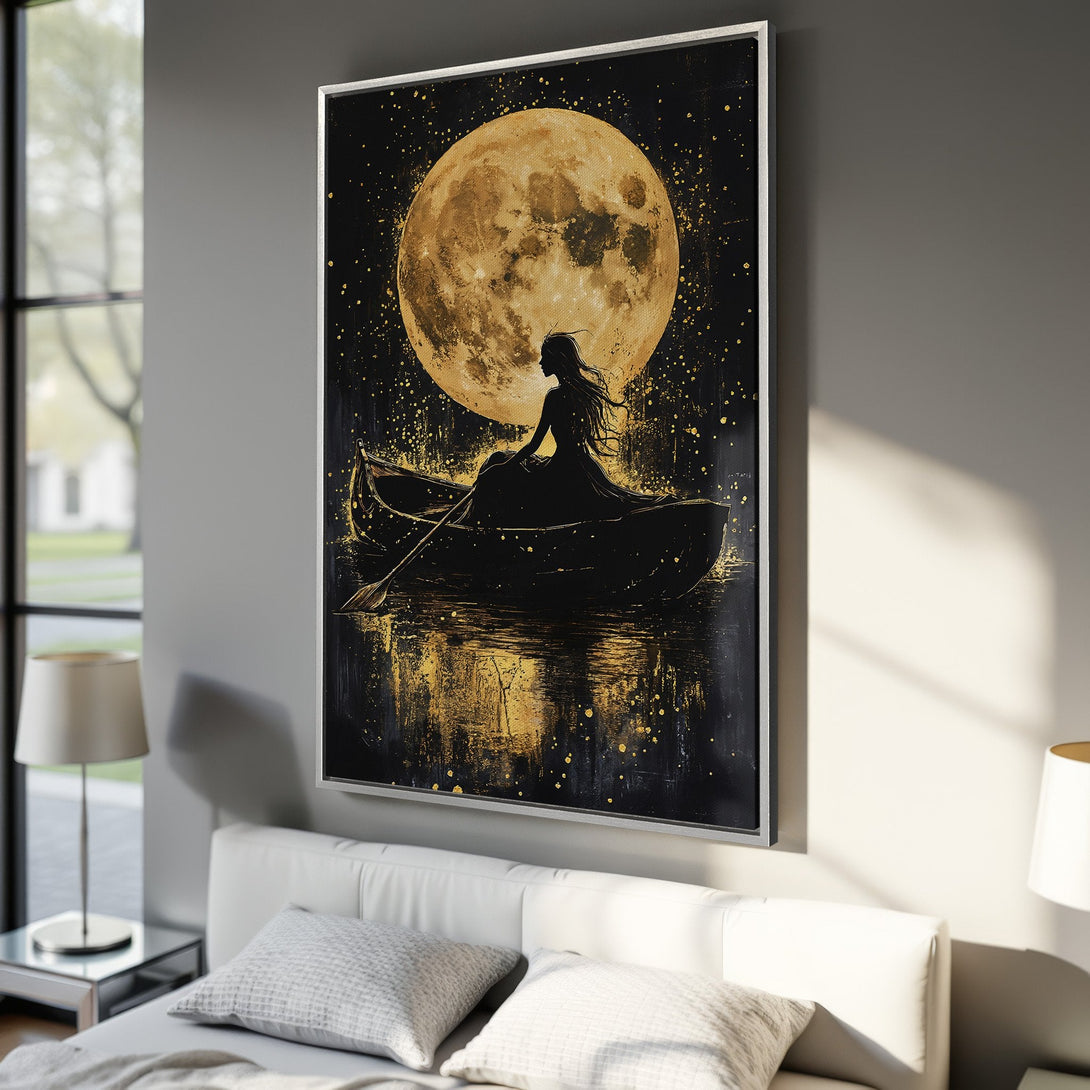 Framed Wall Art: Silhouette of woman in boat under a golden moon. Black & gold abstract art canvas print, perfect for bedroom decor.