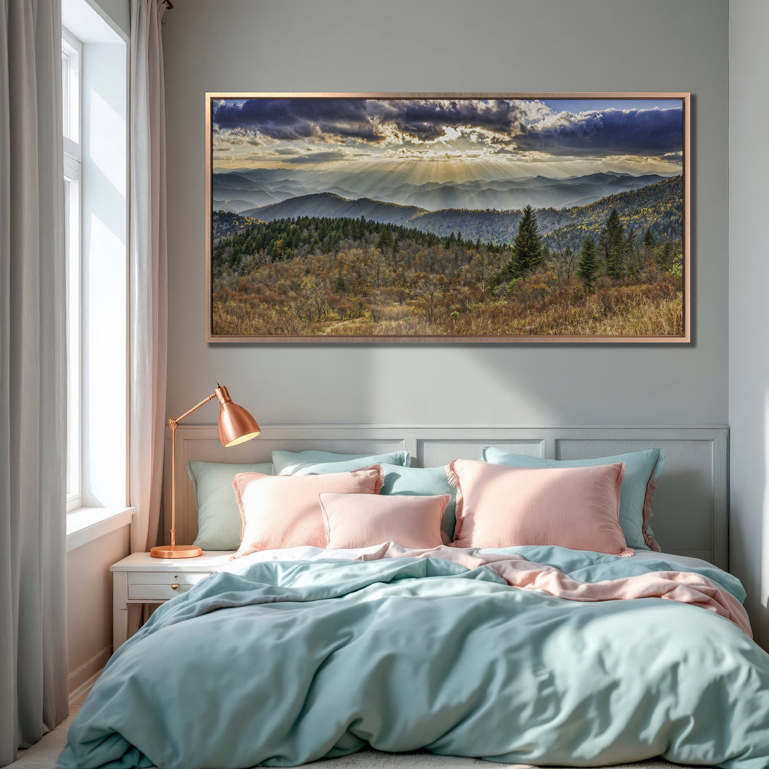 Framed Wall Art of a mountain landscape with dramatic sky, displayed in a serene bedroom with a pastel color palette. Bring nature's beauty indoors!