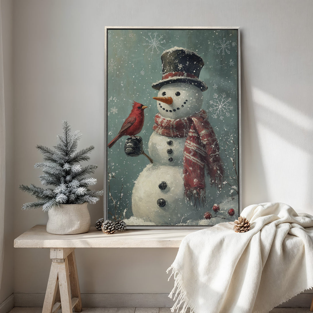 Framed Wall Art featuring a charming snowman with a cardinal in a winter scene. Rustic style, with a soft blue, white, and red color palette. Perfect holiday decor.