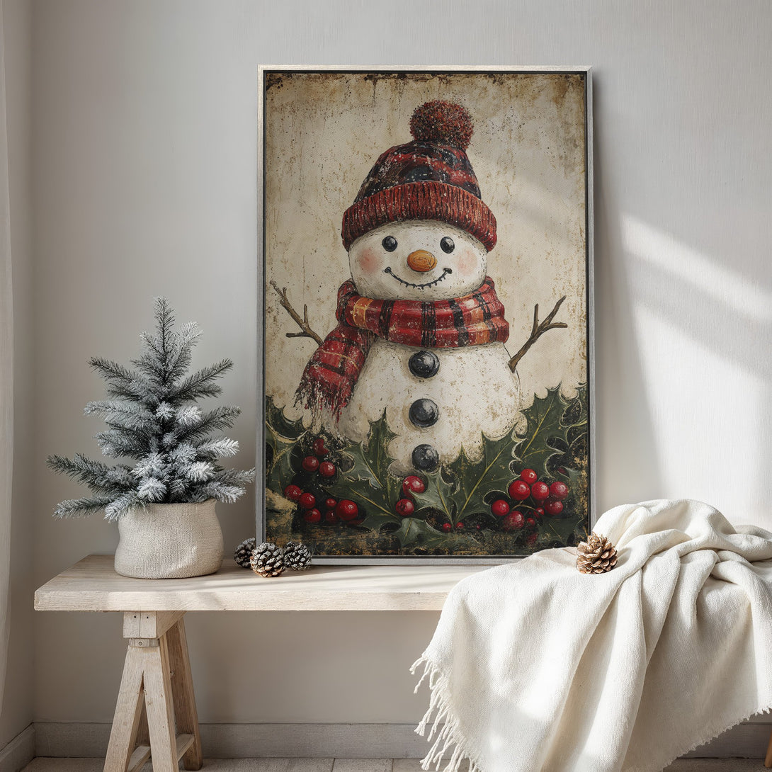 Framed Wall Art featuring a charming snowman with a red and black plaid scarf and hat, rustic style, warm color palette. Perfect holiday decor!
