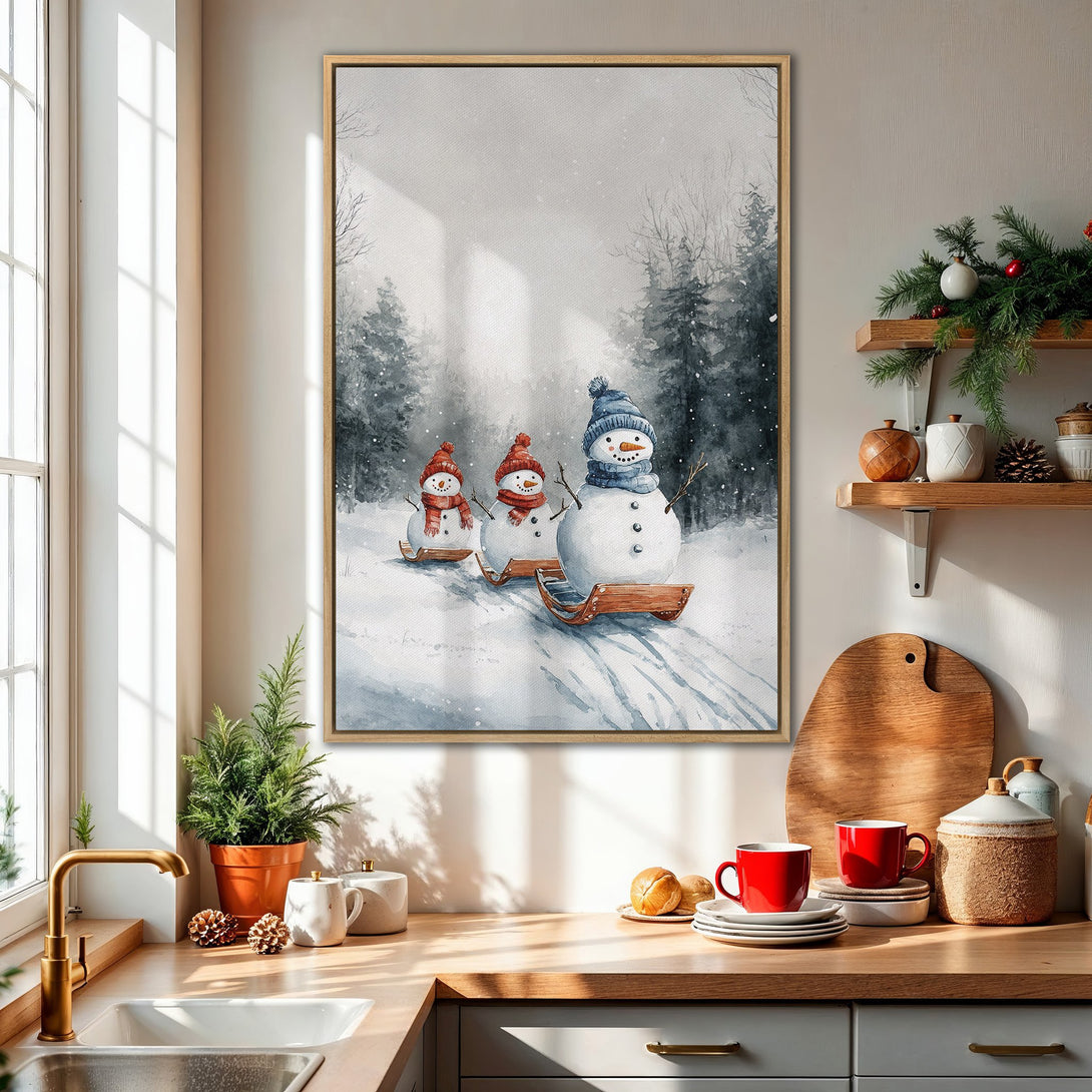 Framed Wall Art featuring a whimsical watercolor of snowmen sledding in a winter forest. Soft, muted blue and gray color palette, perfect for holiday decor.