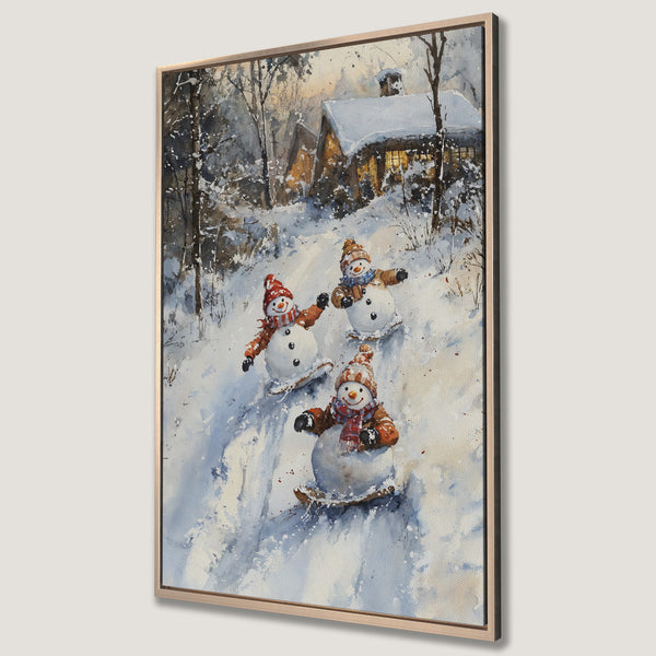 Framed Wall Art featuring a watercolor painting of snowmen sledding in a winter wonderland. Charming, whimsical art with a cool blue and warm orange palette.