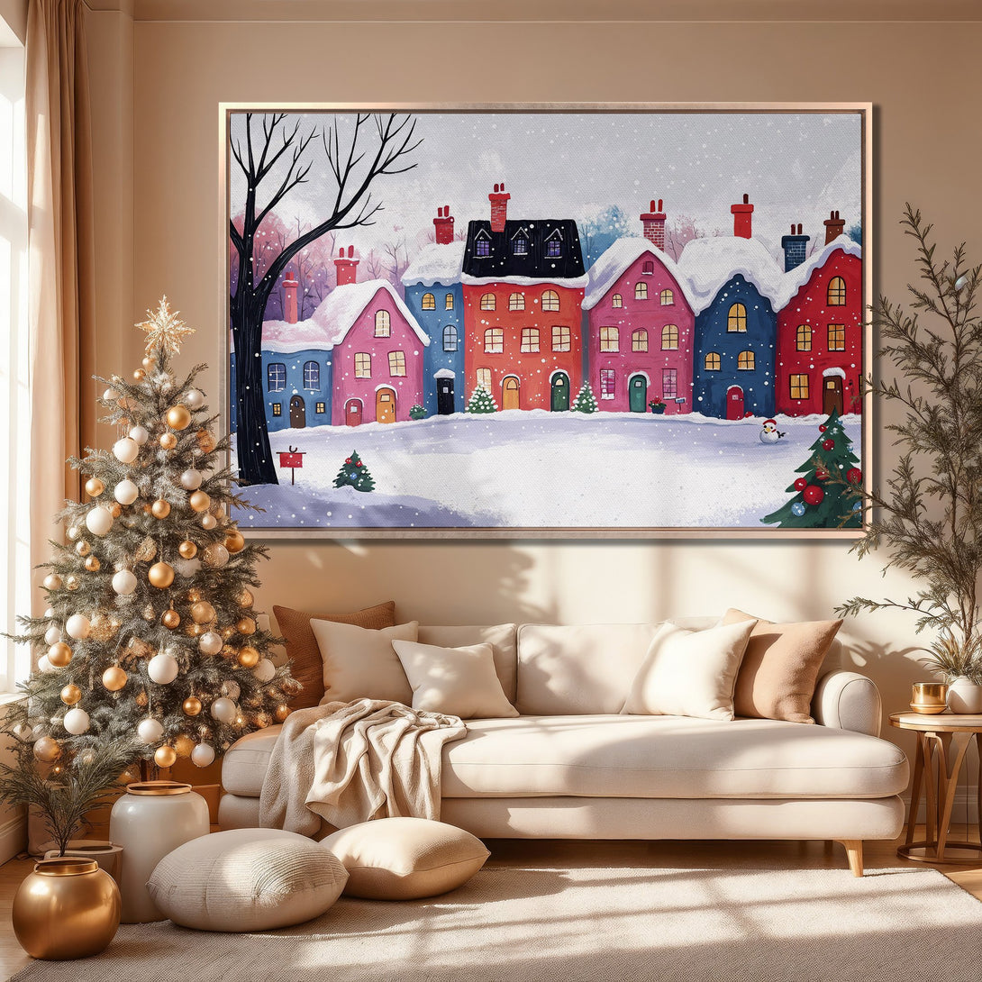 Framed Wall Art featuring a whimsical winter village scene with colorful houses, snow, and a neutral-toned interior. Perfect holiday decor!