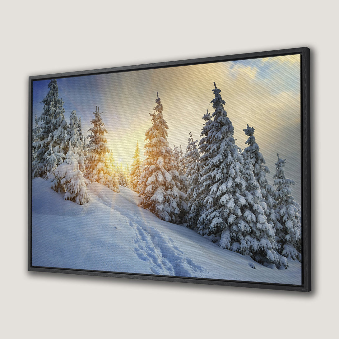 Framed Wall Art of a snowy winter landscape with pine trees, featuring a warm sunset. Serene, natural scene with blue, white, and golden hues. Perfect for home decor.