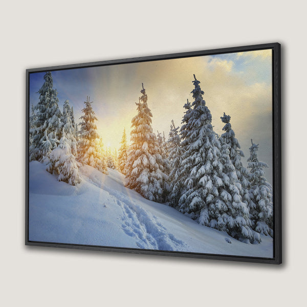 Framed Wall Art of a snowy winter landscape with pine trees, featuring a warm sunset. Serene, natural scene with blue, white, and golden hues. Perfect for home decor.