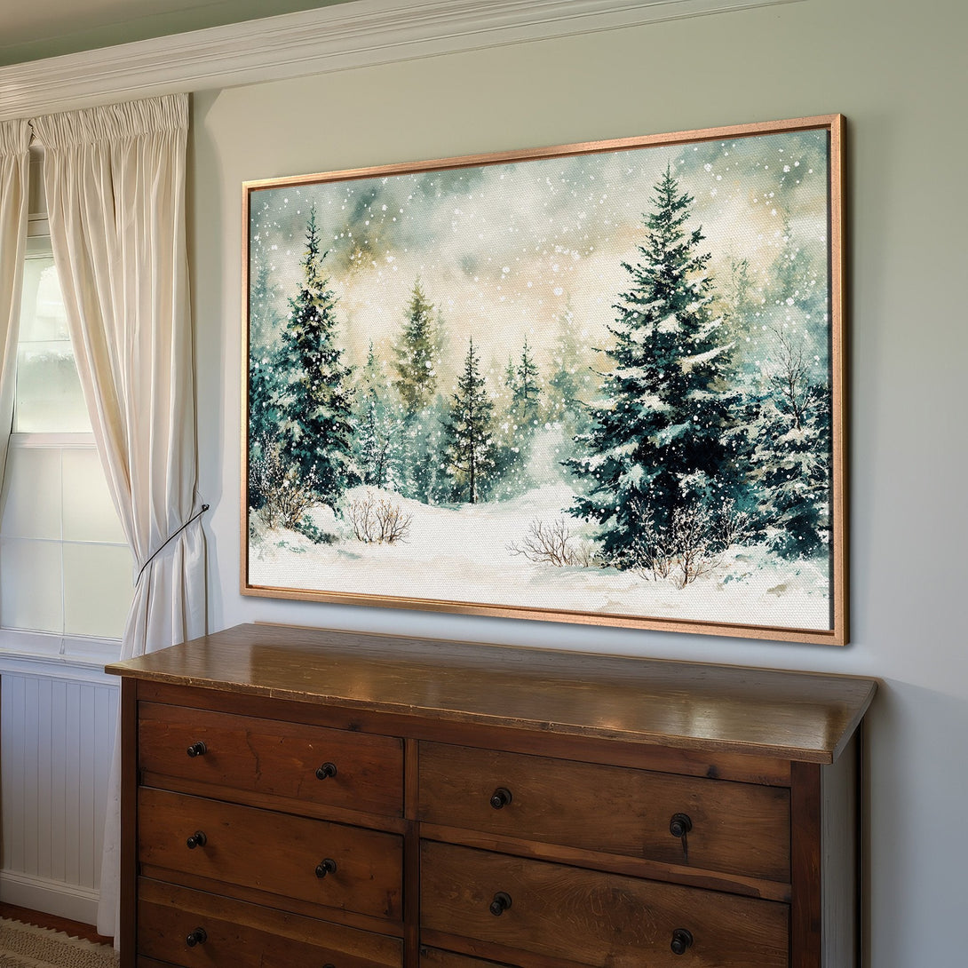 Framed Wall Art of a snowy forest scene. Watercolor style with a teal and beige color palette. Perfect for adding a touch of nature to your home.