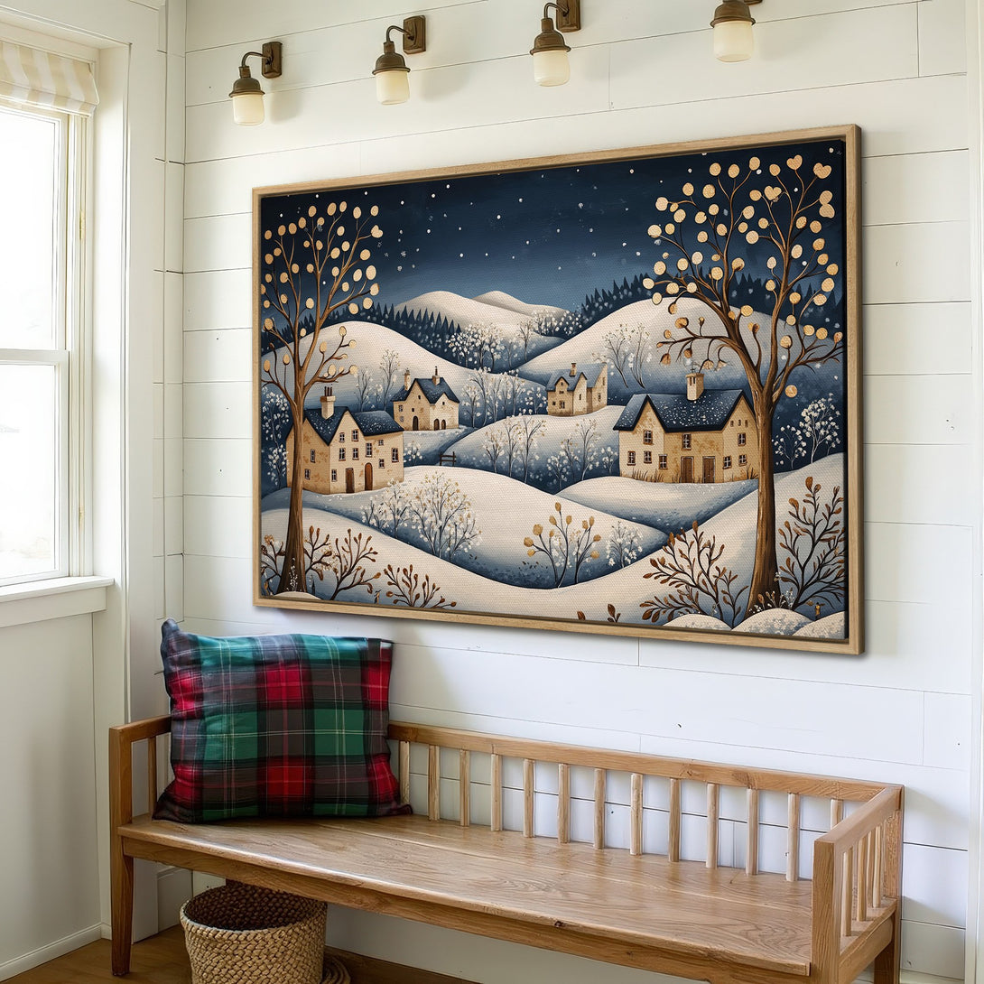 Framed Wall Art: Winter landscape Canvas Print in a cozy interior. Featuring whimsical houses, trees, and a calming blue and gold color palette. Perfect for home decor.