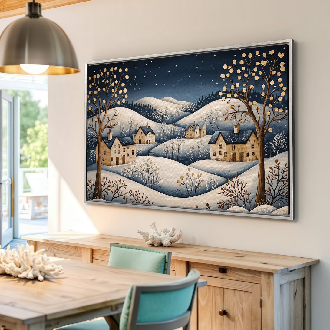 Framed Wall Art: Winter village scene in whimsical style, featuring snowy hills & houses. Blue, gold, and neutral color palette. Perfect home decor.
