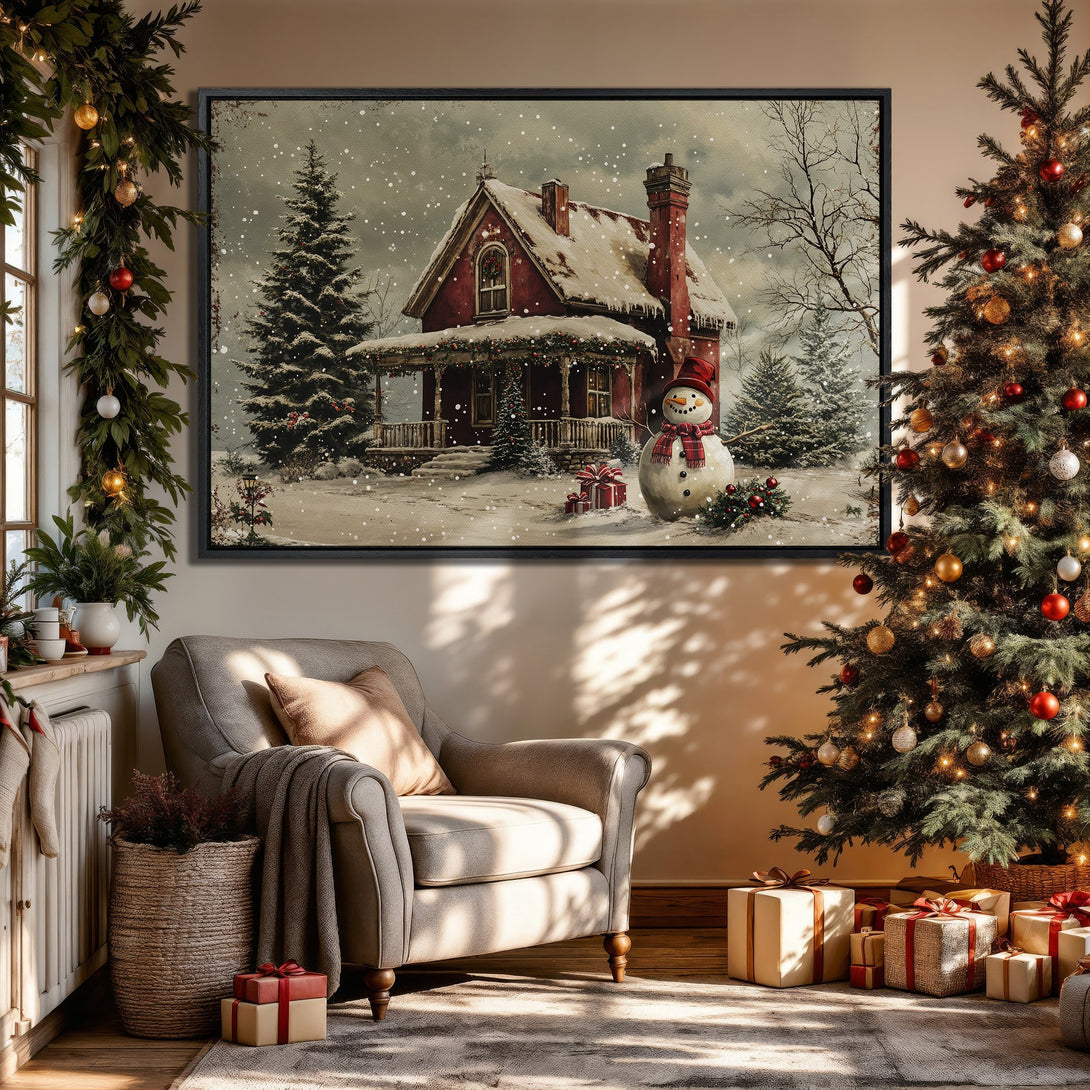 Framed Wall Art: Winter scene with red house and snowman, displayed in cozy interior with Christmas tree. Warm, inviting color palette.