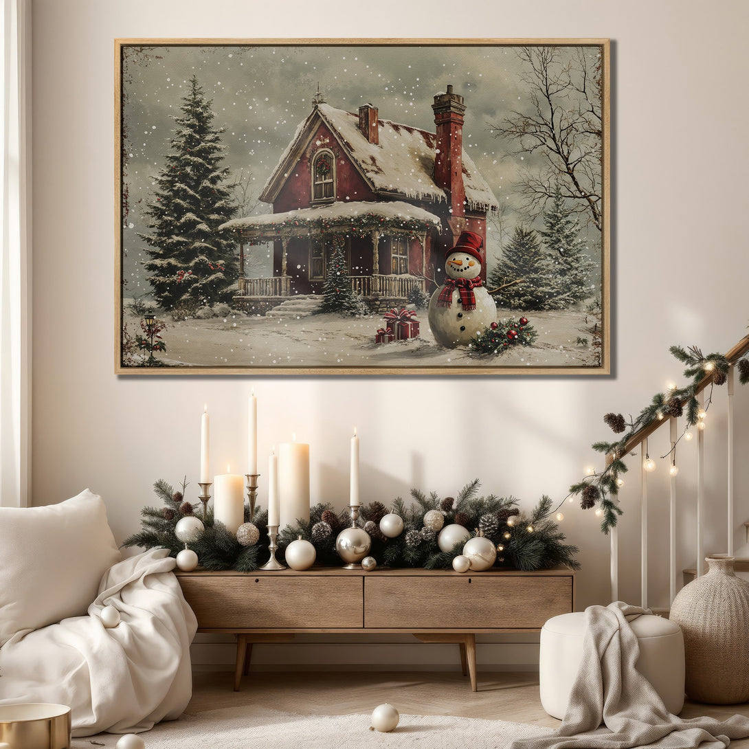 Framed Wall Art featuring a cozy winter scene with a red house and snowman. Warm, inviting color palette perfect for holiday decor.