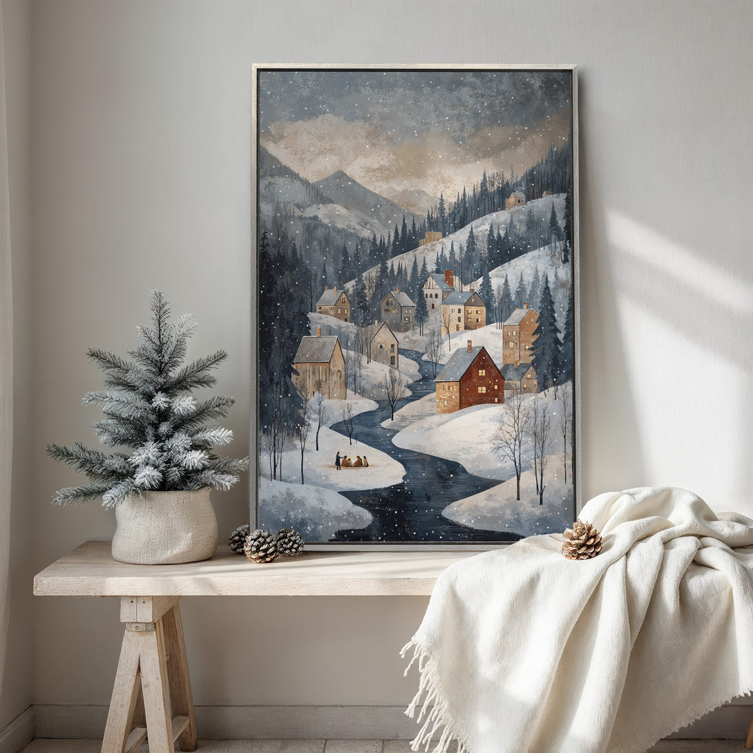 Framed Wall Art of a snowy village scene in a muted blue and brown palette. Perfect for adding a cozy, wintery touch to your home decor.