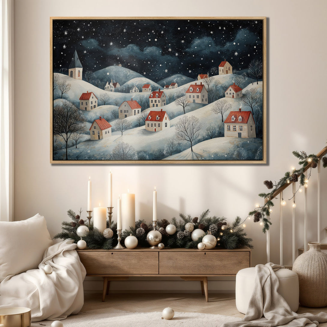 Framed Wall Art: Winter village scene canvas print with red-roofed houses, snowy hills, and a starry night sky. Perfect for cozy home decor, blue and white palette.