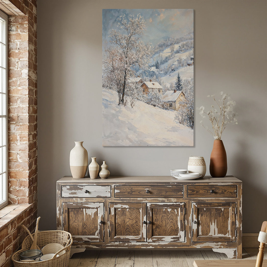 Framed Wall Art: Winter landscape painting in a dining room. Features a snowy scene with houses, trees, and a soft blue and white color palette.