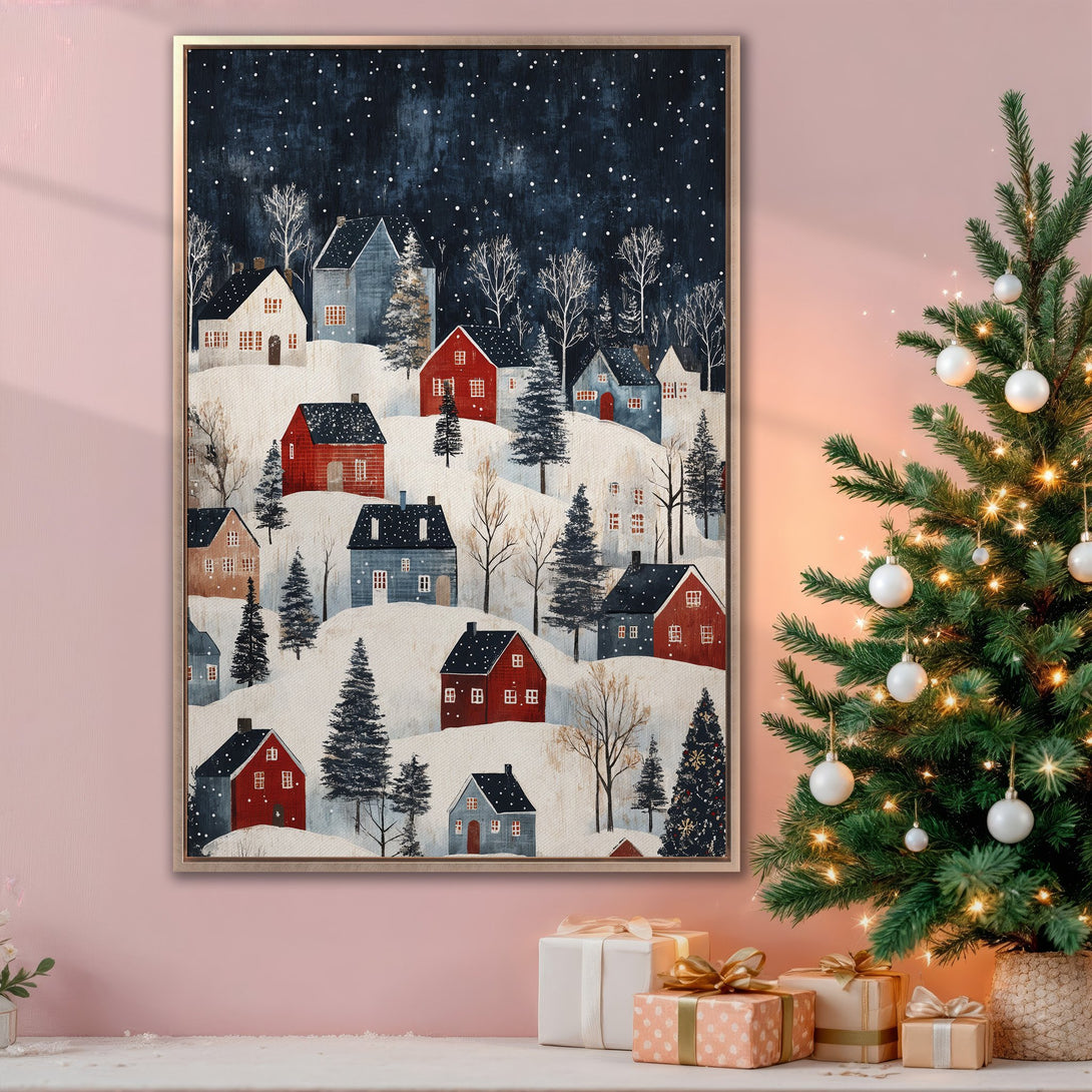 Framed Wall Art: Winter village scene in a folk art style, featuring red and blue houses on snowy hills, with a dark blue sky. Cozy & festive decor.