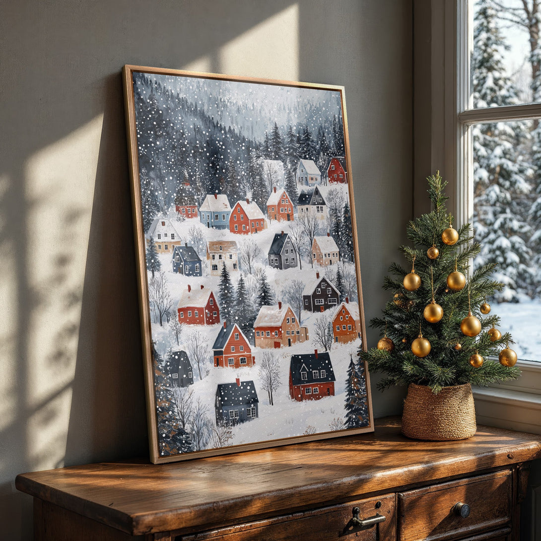 Framed Wall Art: Winter village scene in a cozy interior. Featuring a snowy landscape with colorful houses, a blue and red palette, perfect for holiday decor.