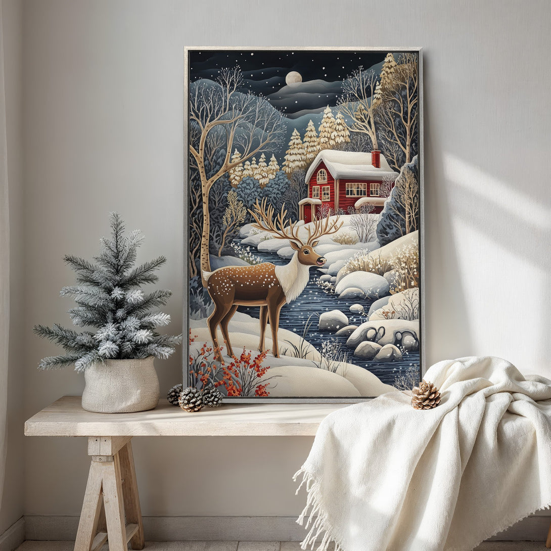 Framed Wall Art: Winter scene with deer, red cabin, and snowy landscape. Cozy, whimsical style with a blue, white, and red color palette. Perfect for holiday decor!