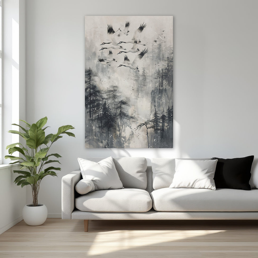 Framed Wall Art featuring a flock of cranes in flight over a misty forest. Elegant black, white, and gray artwork, perfect for adding a touch of sophistication.