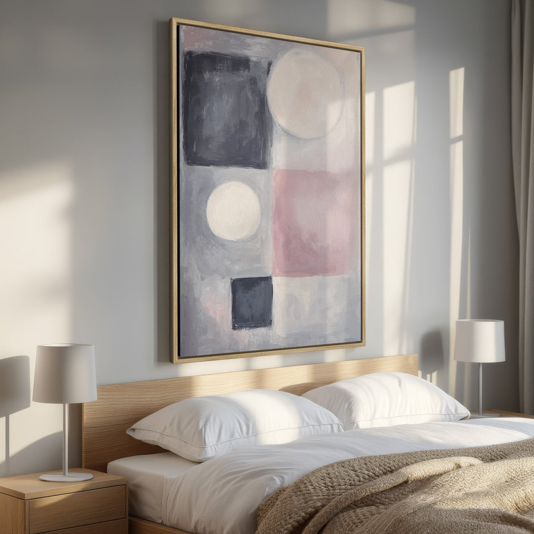 Framed Wall Art featuring an abstract geometric design in a soft gray, pink, and white color palette. Perfect for modern bedroom decor.