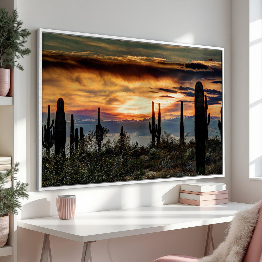 Framed Wall Art of a desert sunset with cacti. Warm orange and gold hues create a dramatic landscape. Add this stunning Canvas Print to your home!