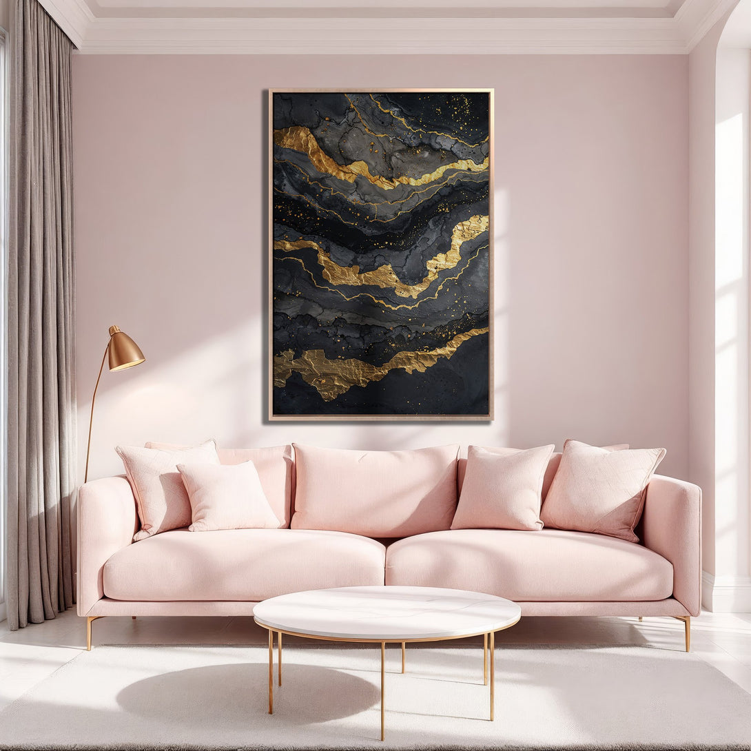 Framed Wall Art featuring an abstract black and gold design. Modern style, displayed in a pink interior with a matching sofa. Perfect for home decor.