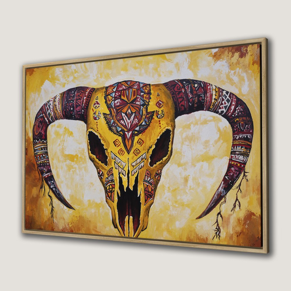 Boho-chic Canvas Print featuring a vibrant, decorated bull skull in warm yellow and red tones. Add a touch of Southwestern style to your home!