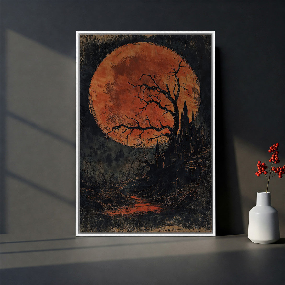 Framed Wall Art featuring a spooky castle under a blood moon. Dark, moody art with a vintage style and a warm, orange and black palette. Perfect for Halloween decor.