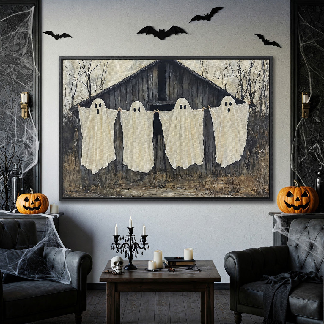 Framed Wall Art: Spooky Halloween canvas print featuring ghosts hanging on a line, with a neutral color palette and dark frame. Perfect for seasonal decor!