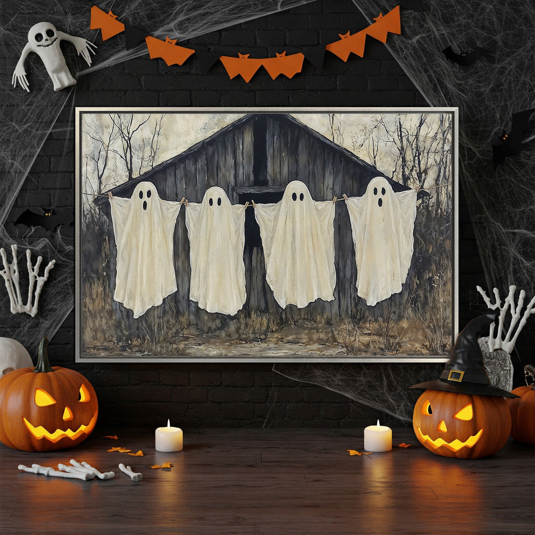 Framed Wall Art of spooky ghosts hanging on a clothesline, perfect Halloween decor. Neutral color palette with orange accents.