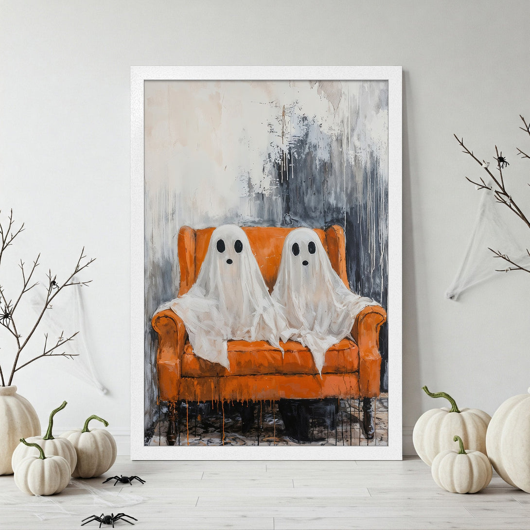 Framed Poster featuring a whimsical Halloween artwork of two ghosts on an orange chair. Modern abstract style with orange, white, and gray color palette.