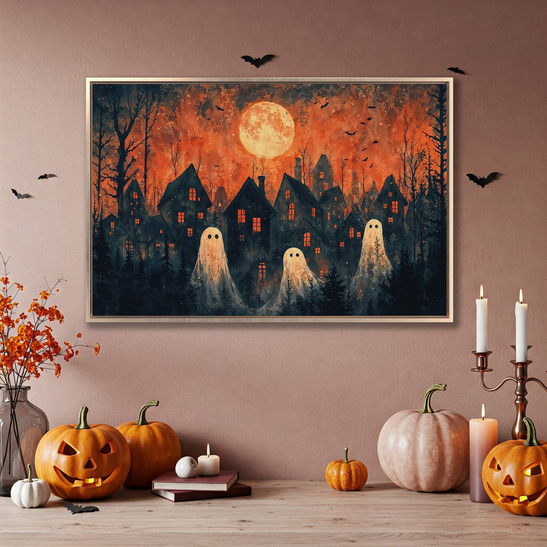 Framed Wall Art: Spooky Halloween scene with ghosts, houses, and a full moon in a warm orange and black palette. Perfect for fall decor!