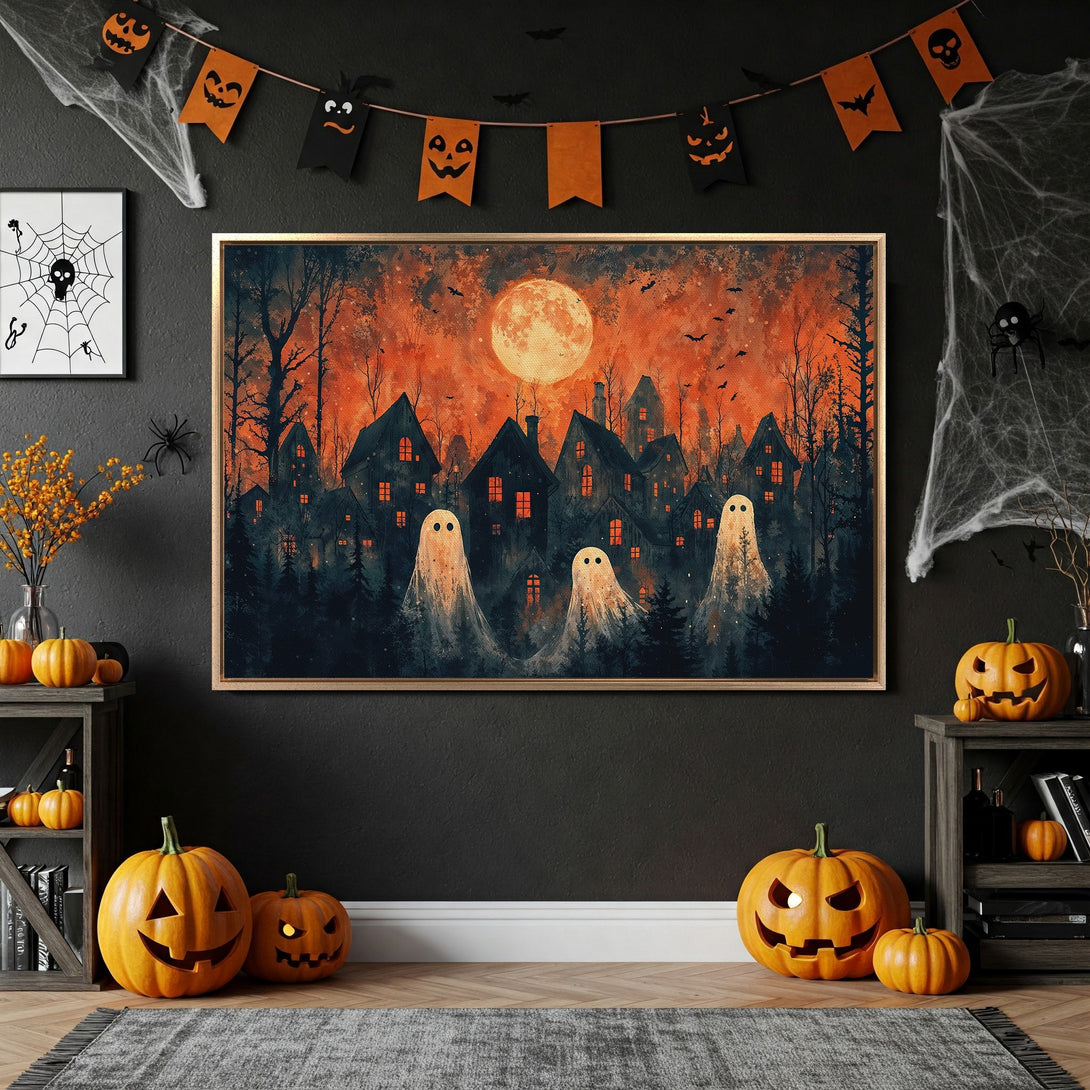 Framed Wall Art: Spooky Halloween scene with ghosts, houses, and a full moon in orange and black. Perfect for seasonal decor!