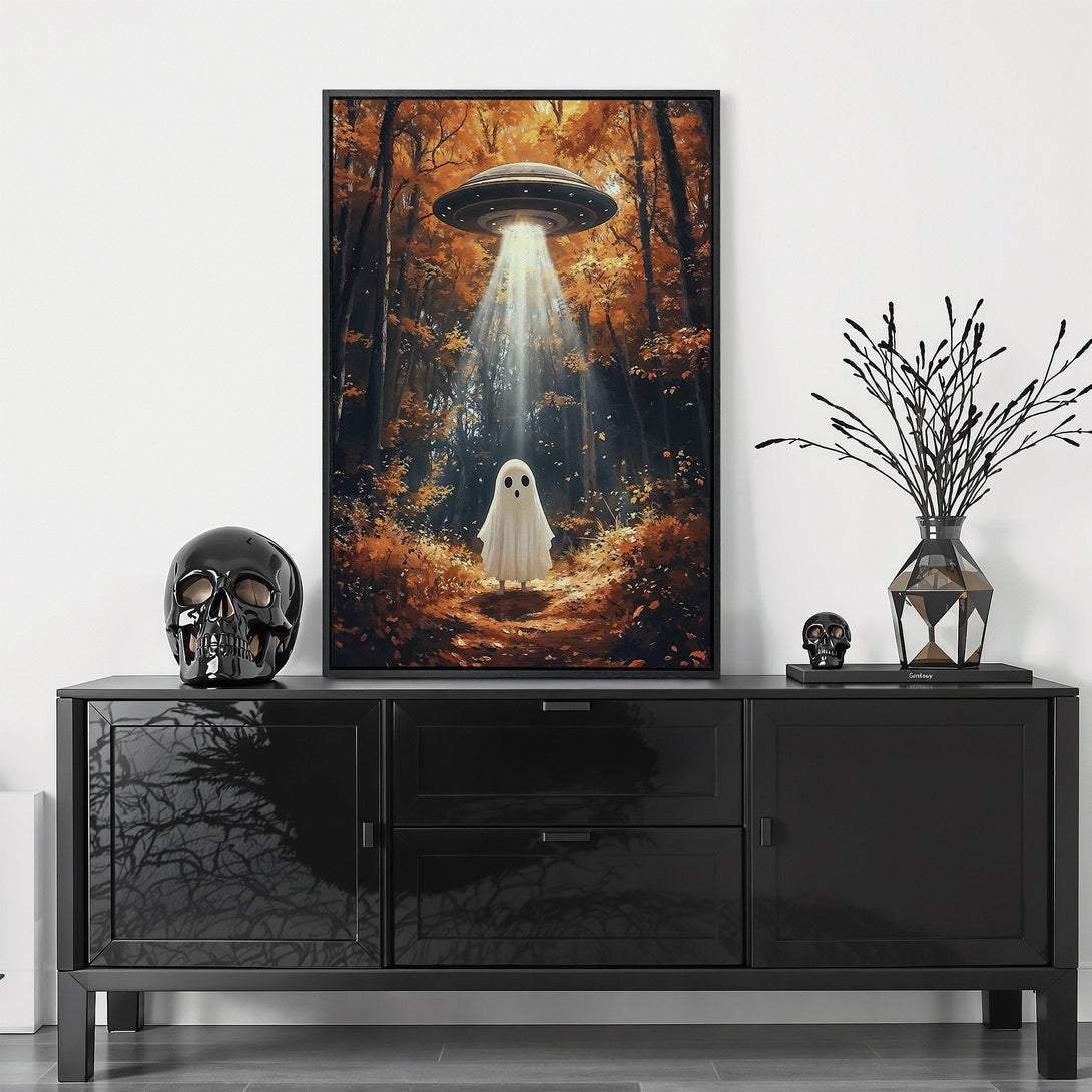 Framed Wall Art featuring a whimsical ghost under a UFO in an autumn forest. Warm orange and brown color palette. Perfect Halloween decor.