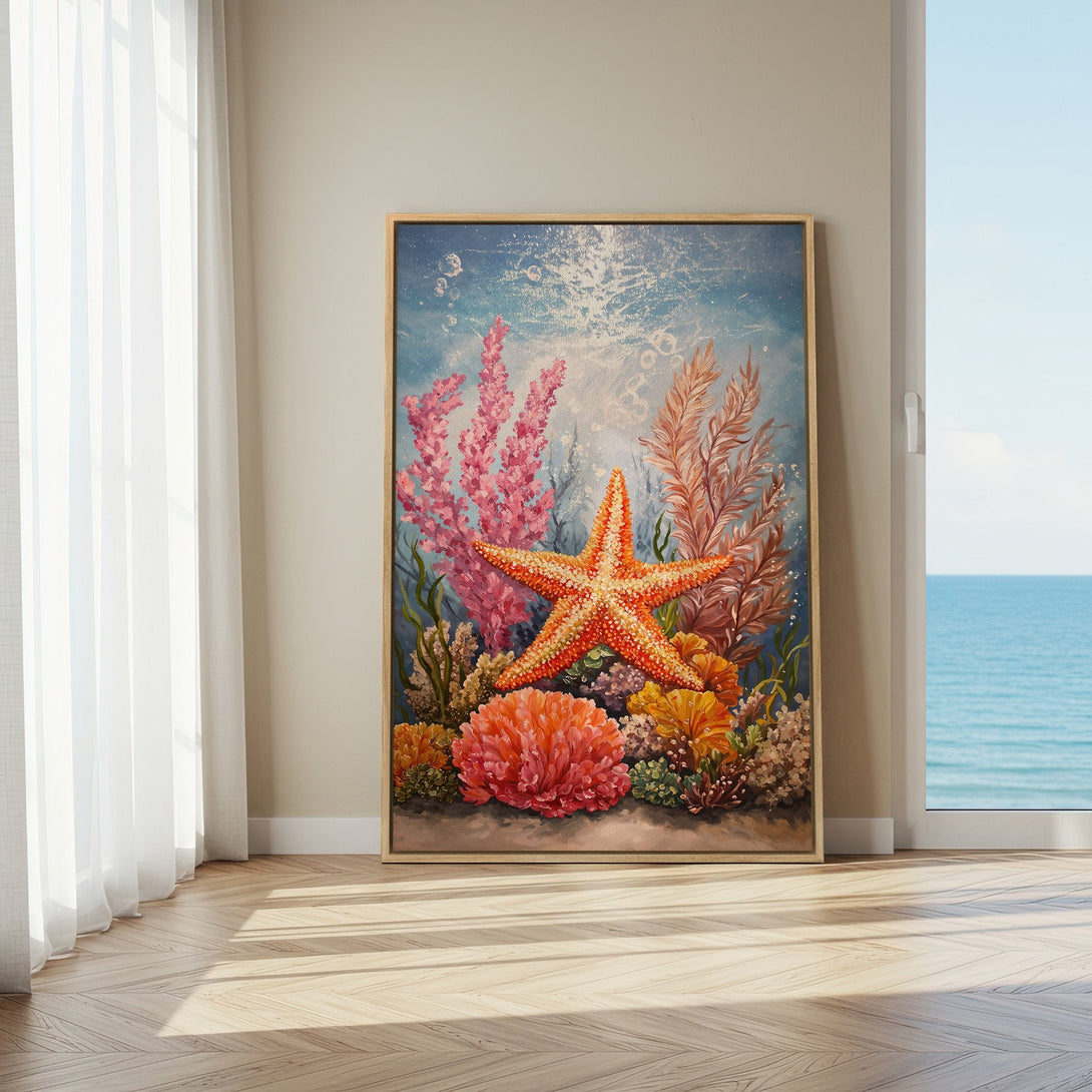 Framed Wall Art featuring a vibrant starfish and coral reef scene in a coastal interior. Warm, inviting colors of orange, pink, and blue. Perfect ocean decor.