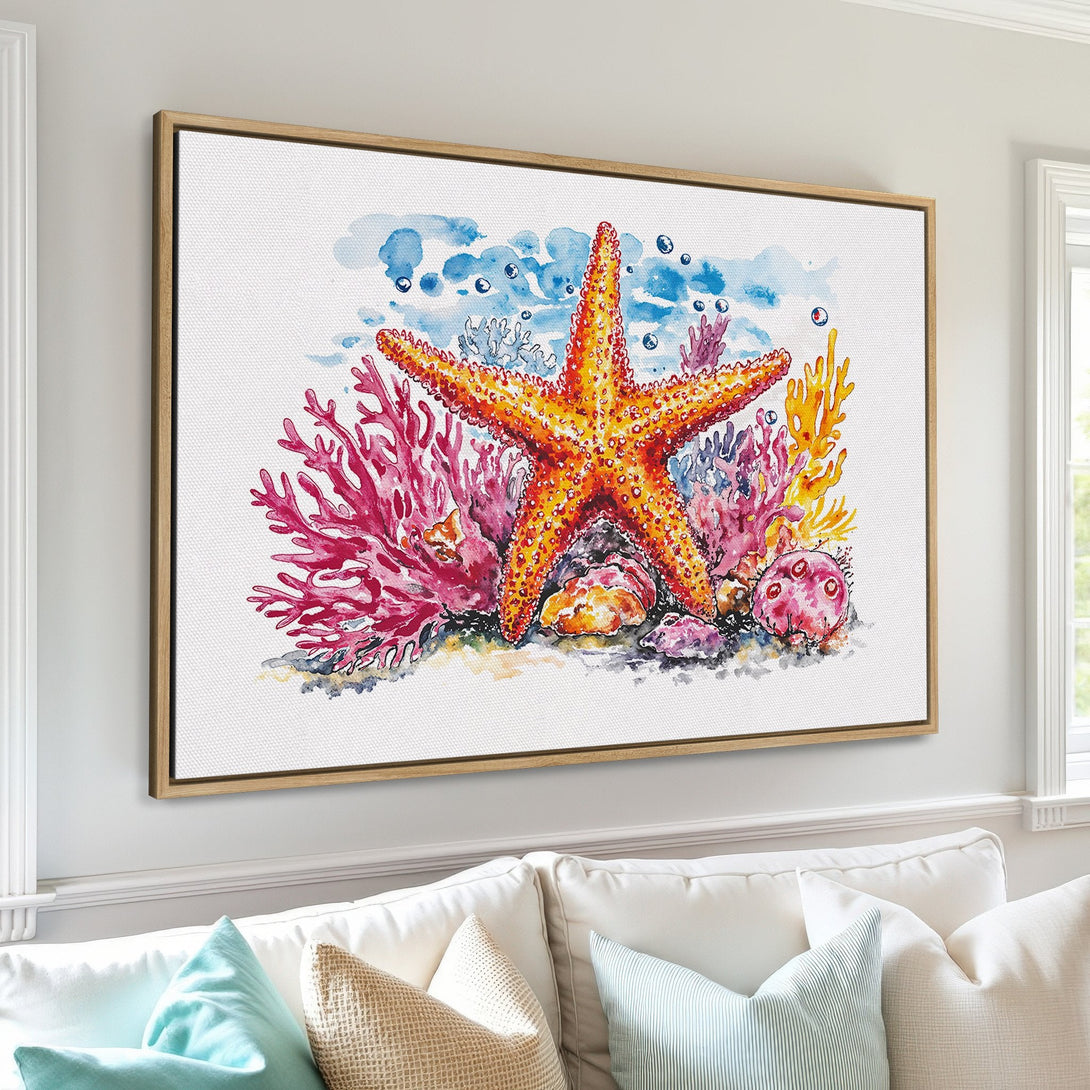 Framed Wall Art featuring a watercolor starfish and coral reef. Coastal style art with vibrant orange, pink, and blue hues. Perfect for beach house decor!