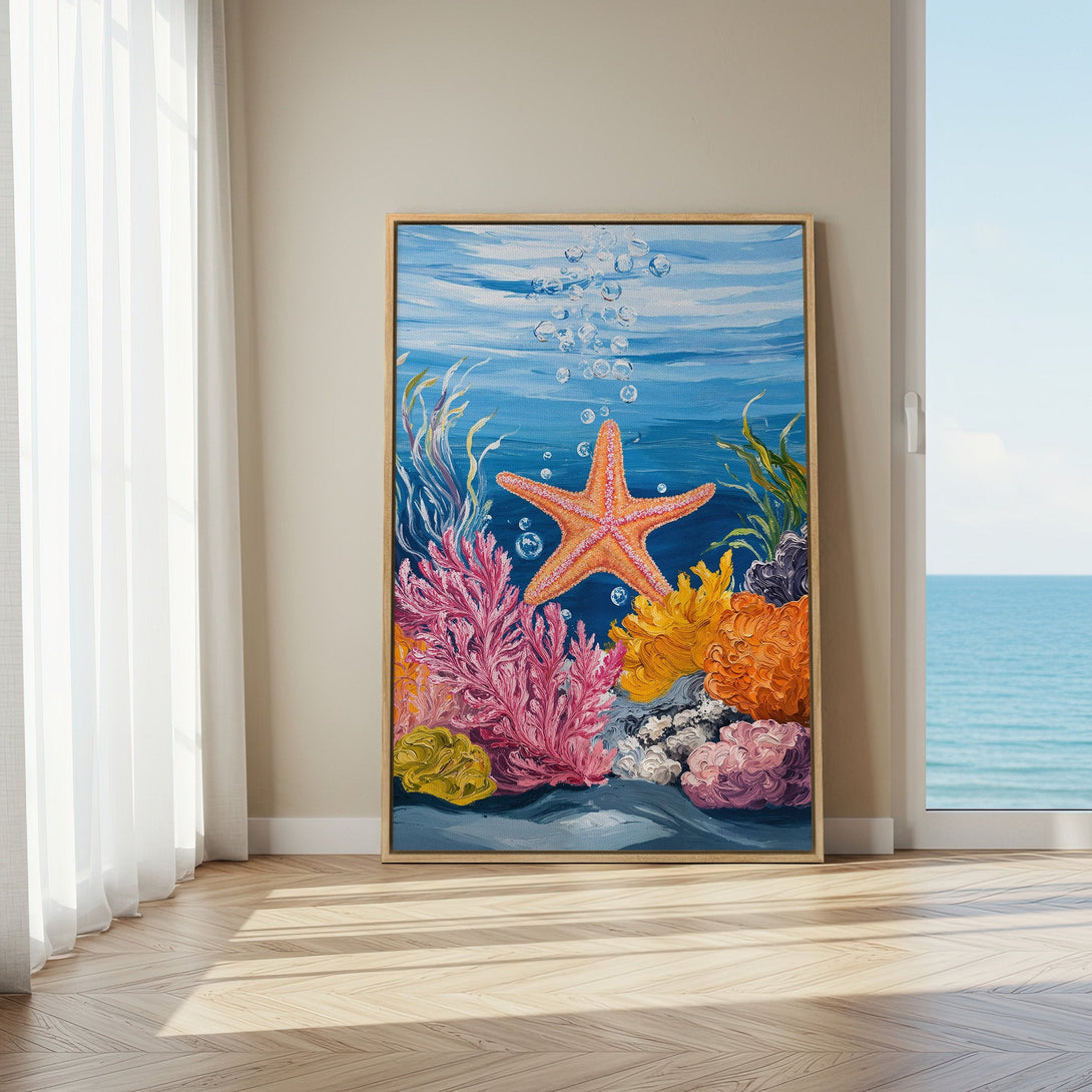 Framed Wall Art featuring a vibrant starfish and coral reef scene in blue, pink, and orange. Coastal decor perfect for any room!