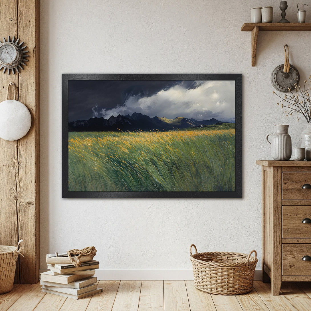 Framed Poster of a dramatic landscape painting. Featuring a field of grass, mountains, and moody skies. Earthy tones.