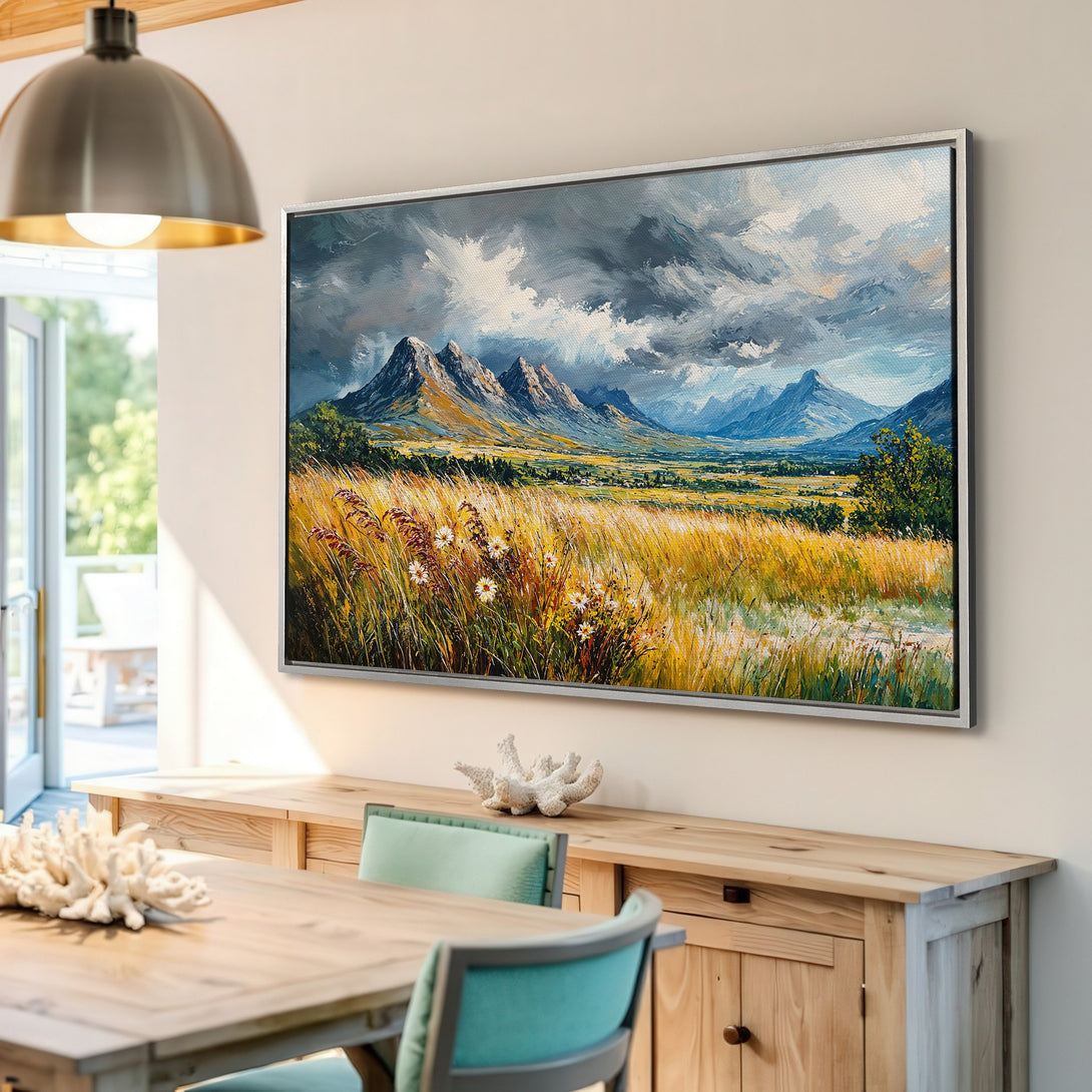 Framed Wall Art: Landscape Canvas Print with mountains, field, and moody sky. Earthy tones of gold, blue, and green create a stunning piece for your home decor.