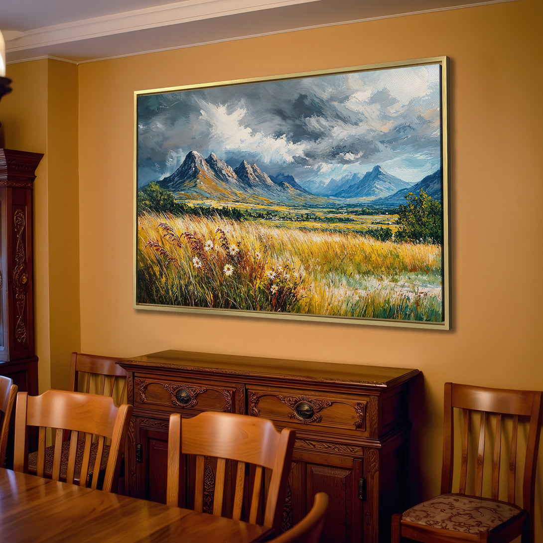 Canvas Print of a mountain landscape painting in a warm, neutral interior. Features a moody, impressionistic style with a blue, green, and golden color palette.