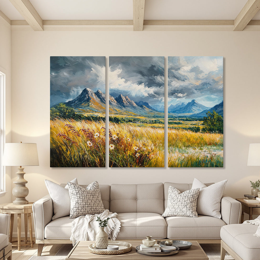 Canvas Print of a mountain landscape painting in a living room. Features a warm color palette with yellow, green, and blue hues.