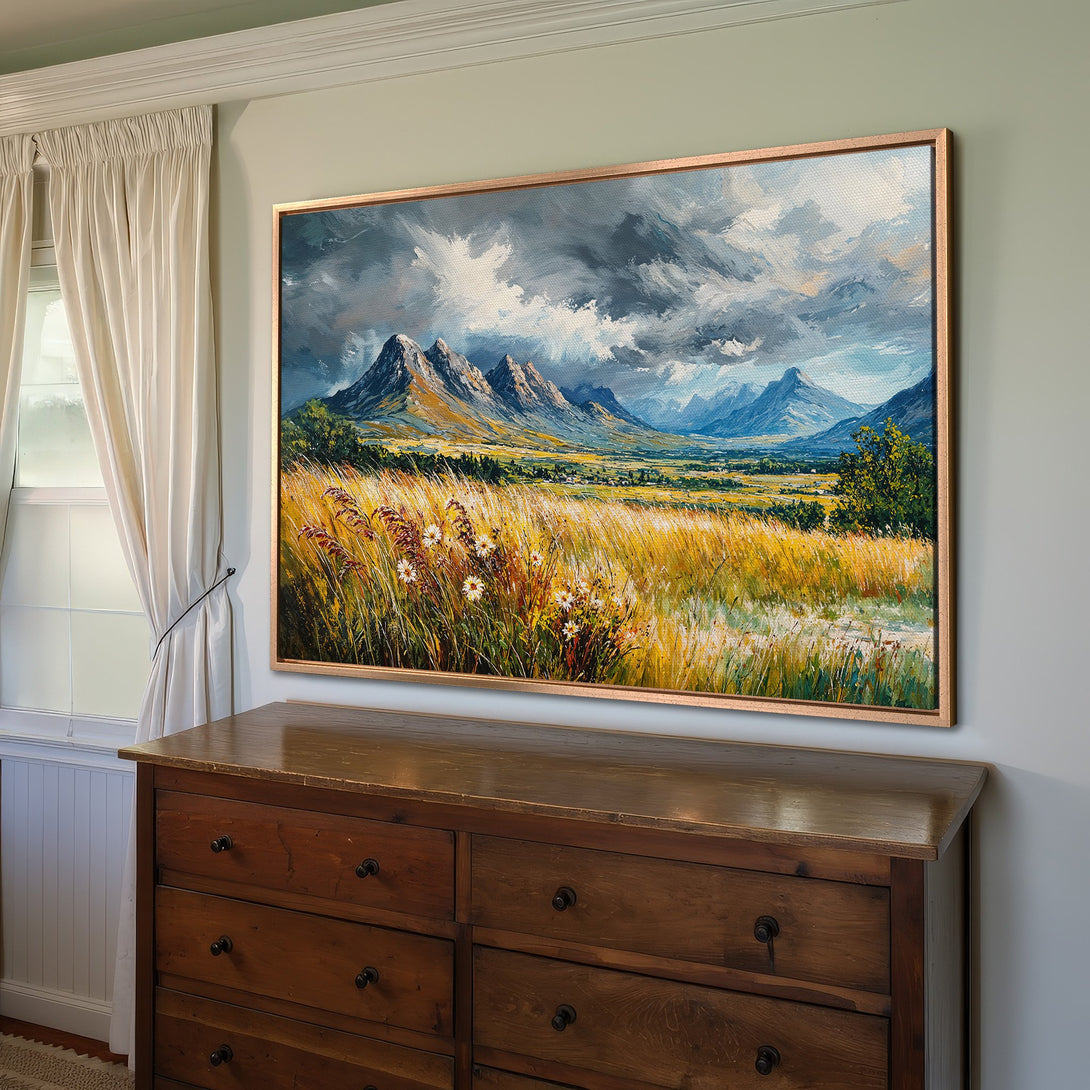 Framed Wall Art: Stunning landscape Canvas Print with mountains, fields, and dramatic sky. Warm yellows, blues, and greens create a captivating focal point.
