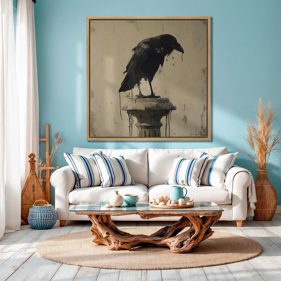 Framed Wall Art: Black raven painting in a coastal living room. Features a neutral palette with pops of blue and natural wood tones for a stylish home decor.